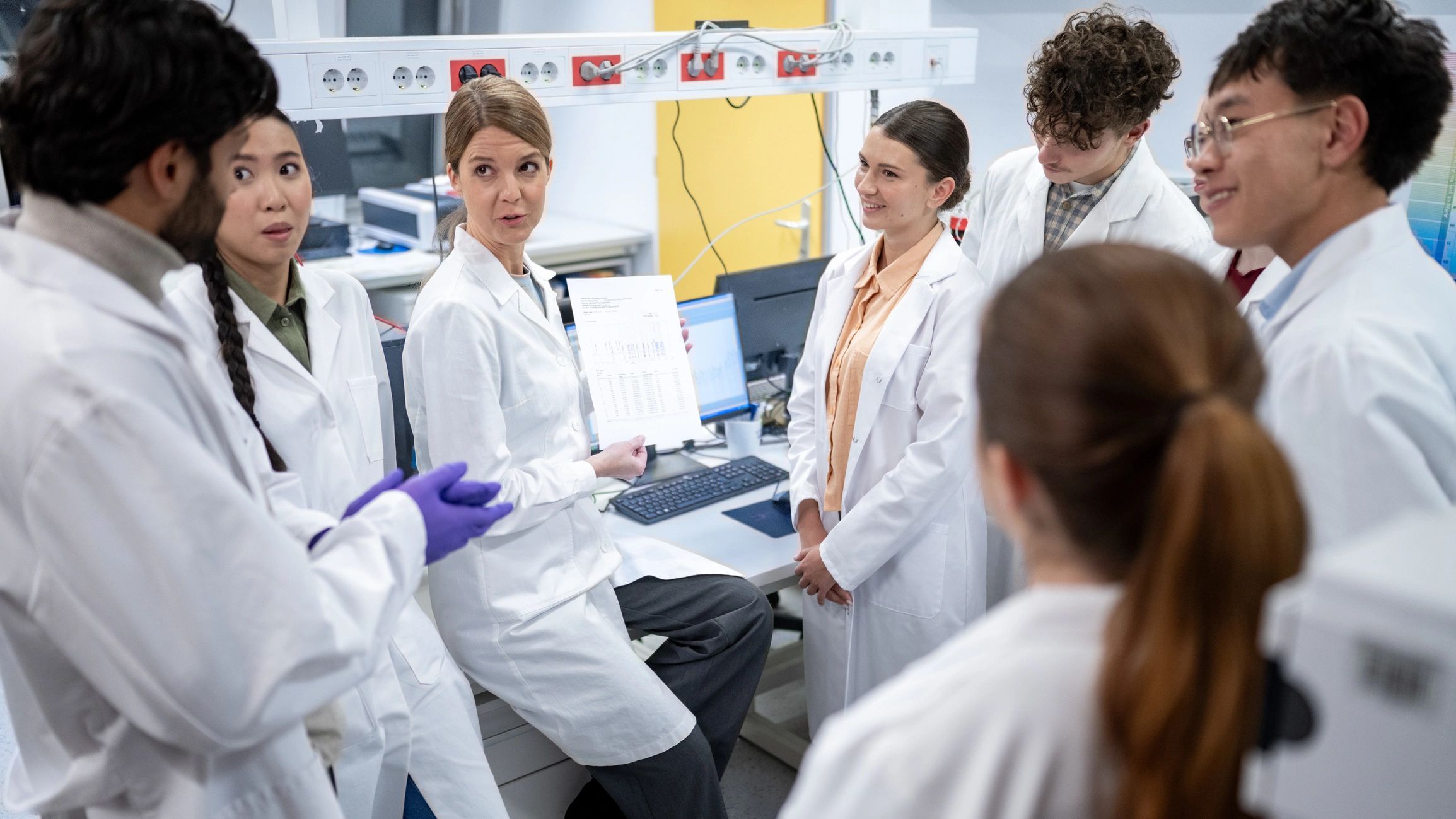 Scientists discussing research findings in a laboratory