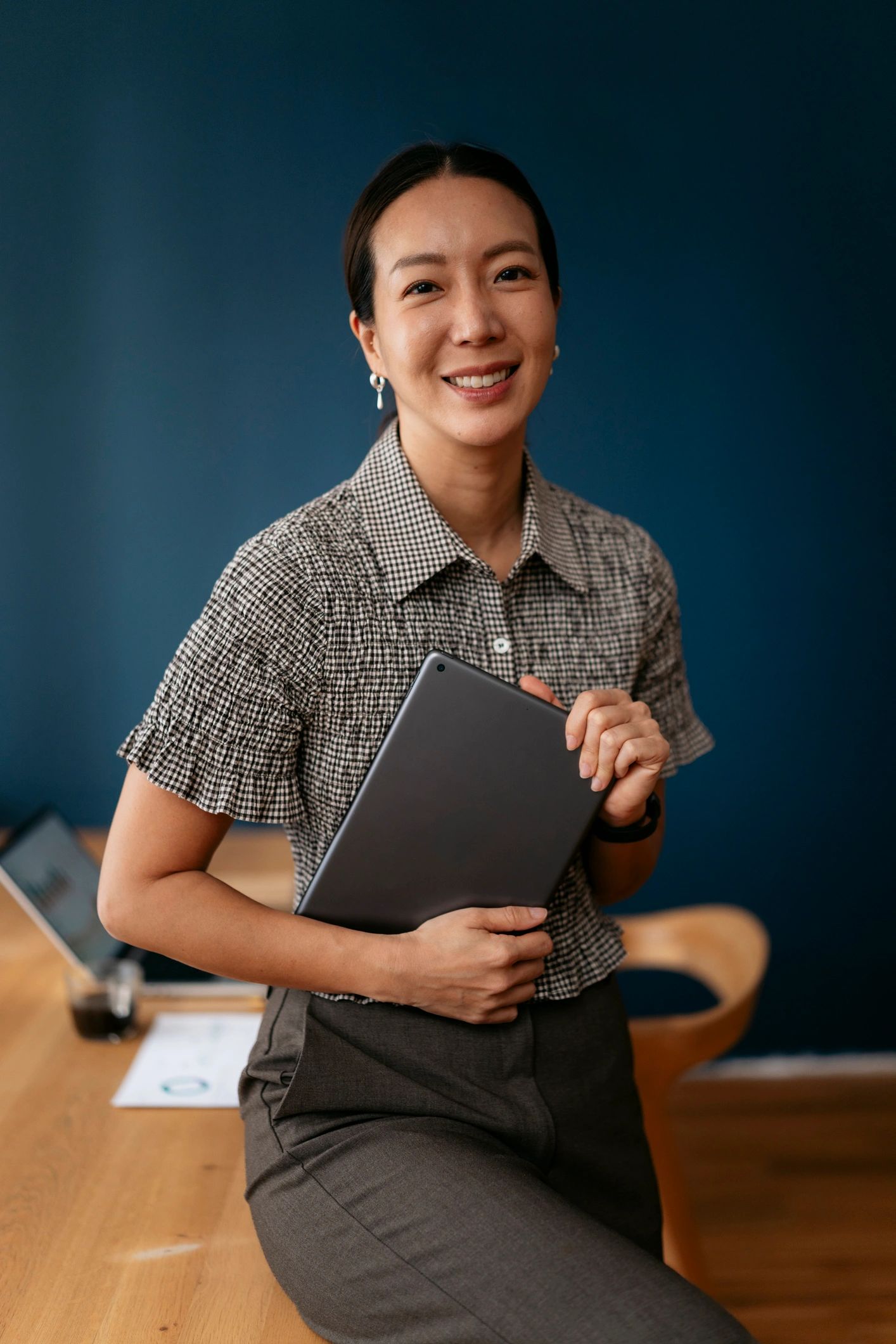 Business leader holding a tablet in a modern office