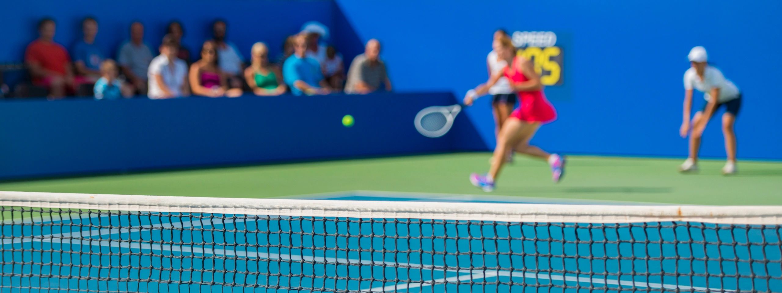Professional tennis player striking the ball during a match